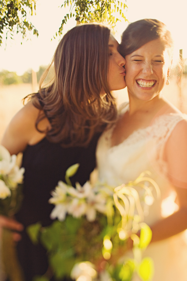 Beautiful Bride Laughing As Bridesmaid Kisses Her On The Cheek Photo By Seattle Based Wedding 7759